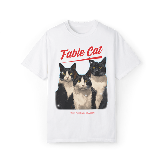 White T-shirt with an illustration of three tuxedo cats, featuring the text 'Fable Cat' in bold red typography above and the subtitle 'The Purring Season' below.