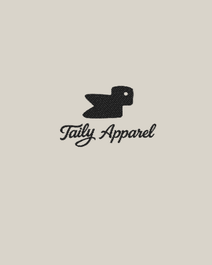 Taily Bird embroidered hoodie detail featuring Taily Apparel logo with black bird design on a neutral background.