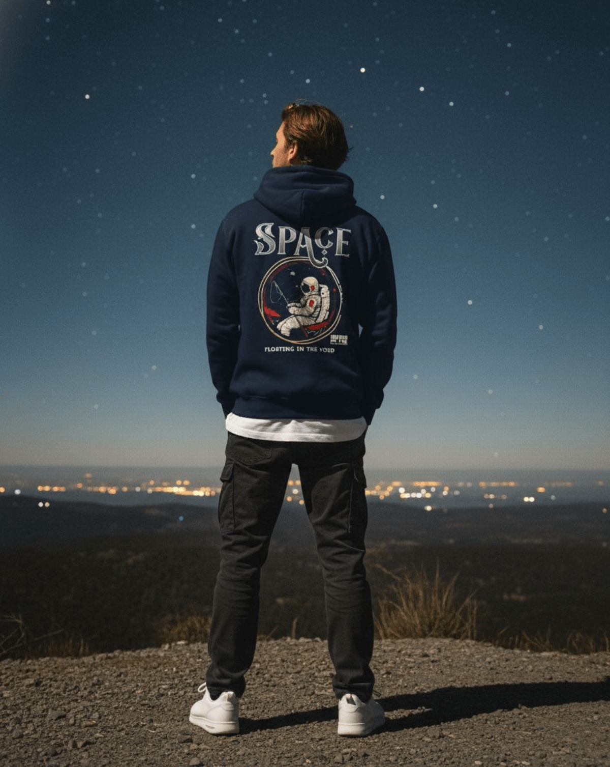 Person wearing Taily Space Club Streetwear Graphic Hoodie, facing stars with astronaut design, navy color.