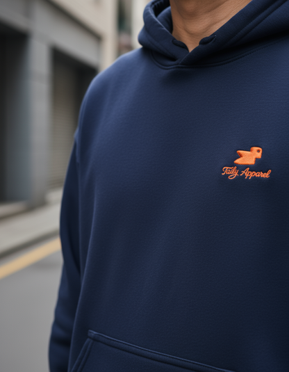 Taily Bird embroidered hoodie in navy with orange bird logo, showcasing minimal streetwear style.
