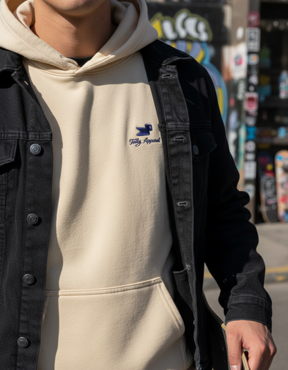 Close-up of a person wearing the Taily Bird embroidered hoodie in Sand with casual streetwear style.