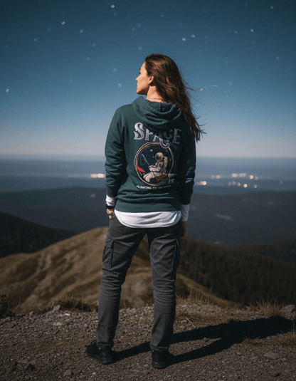 Person wearing Taily “Space Club” Streetwear Graphic Hoodie in sports green against a starry night background.