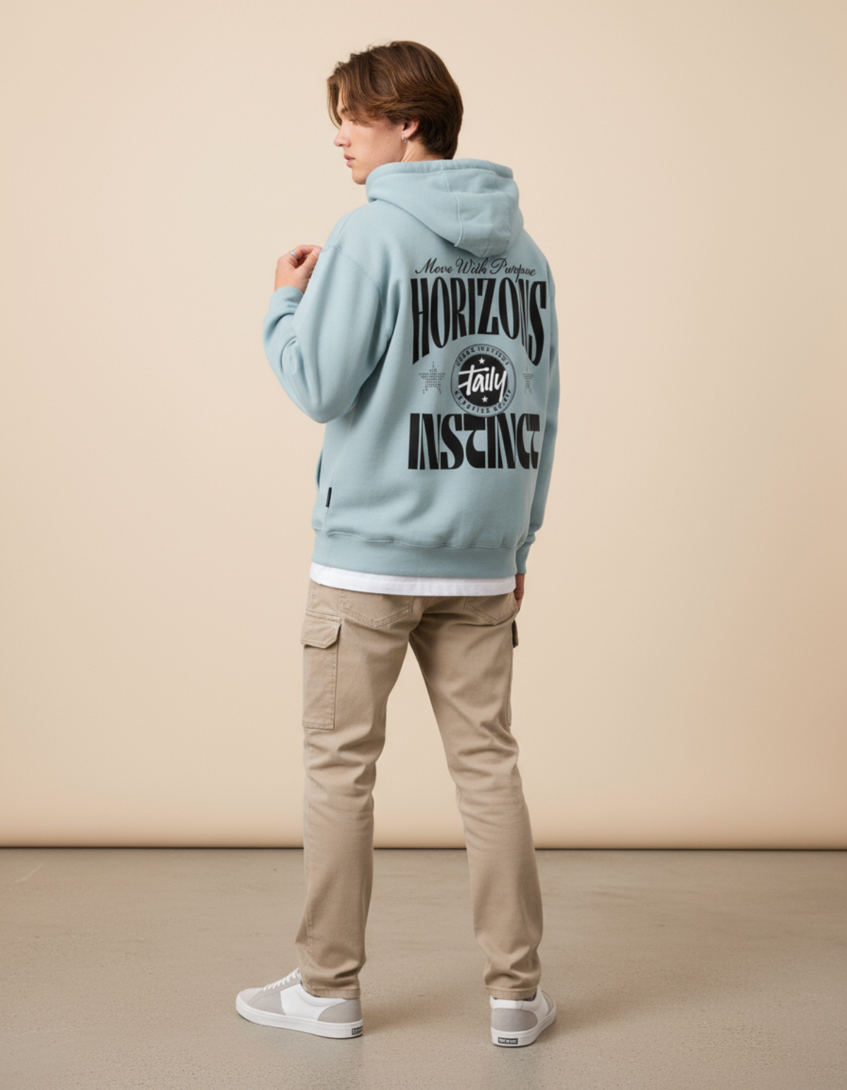 Model wearing Taily Horizons Instinct Hoodie in Blue Mist featuring bold graphics on back.
