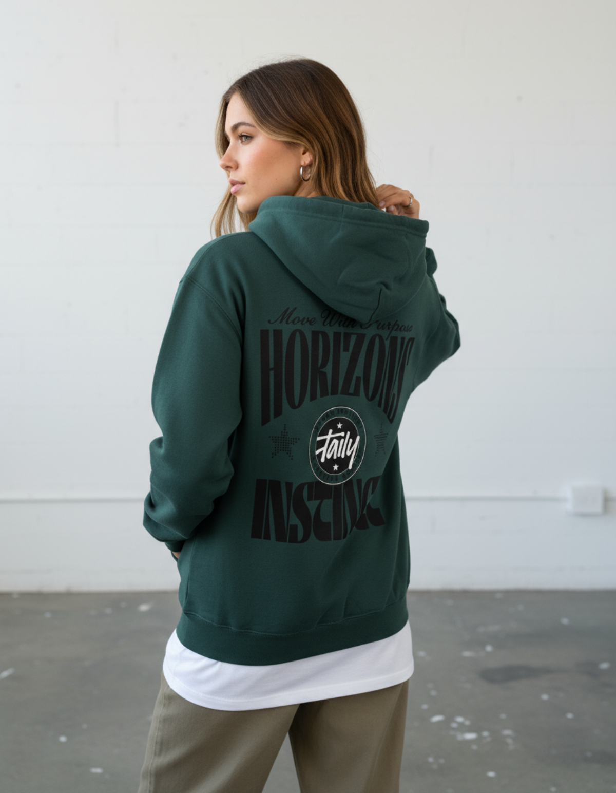Taily Horizons Instinct Hoodie worn from the back in Sports Green with bold text and Taily emblem.