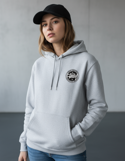 Taily Horizons Instinct Hoodie – Heather Grey worn by a model, showcasing comfort and style in a modern setting.