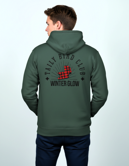 Back view of a man wearing a Taily Bird Club Winter Glow Hoodie in Alpine Green, featuring bold graphics.