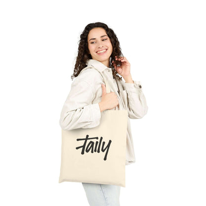 Taily Bird Bold Canvas Tote Bag – Natural / Blue Bird being carried by a smiling woman in casual clothing.