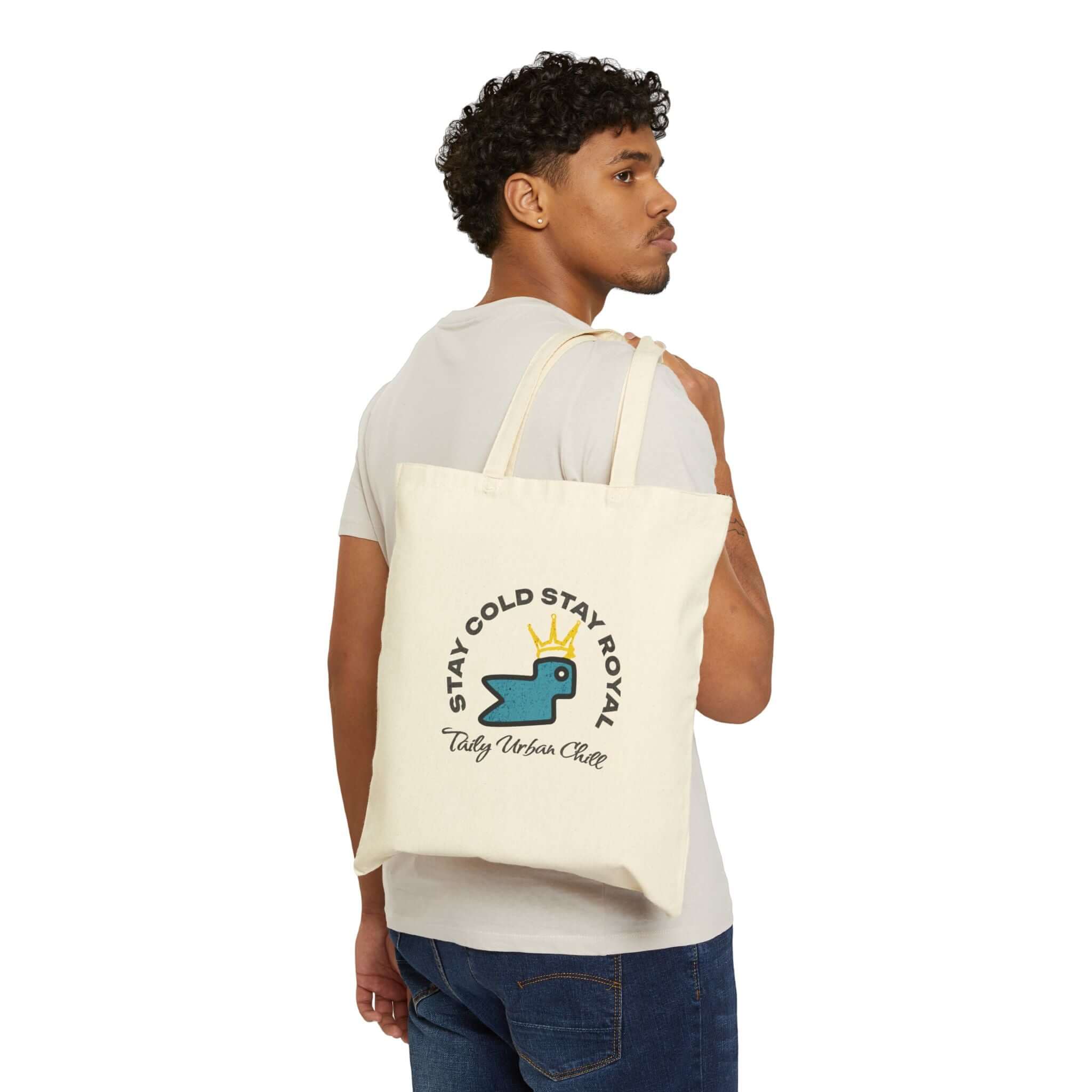 Taily Bird Bold Canvas Tote Bag – Natural / Blue Bird worn by model, showcasing playful design and sturdy handle.