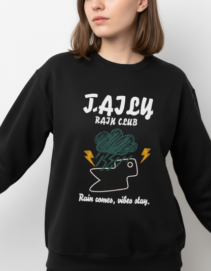 Model wearing Taily Rain Club sweatshirt in Black with weather graphic and text 'Rain comes, vibes stay.'