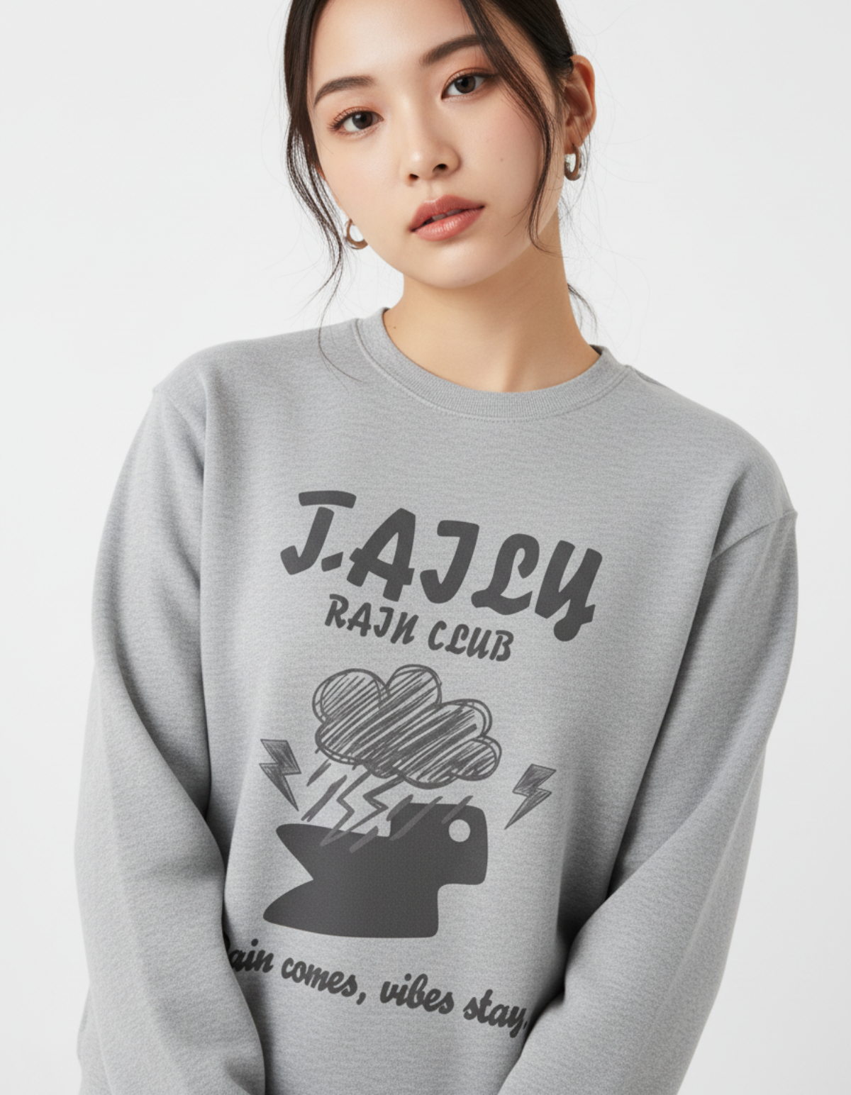 Taily Rain Club sweatshirt in Sport Grey featuring cloud and lightning artwork with the phrase 'Rain comes, vibes stay'.