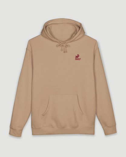 Taily Bird Parkland Hoodie in Sandstone color with bold chest logo and comfortable design.