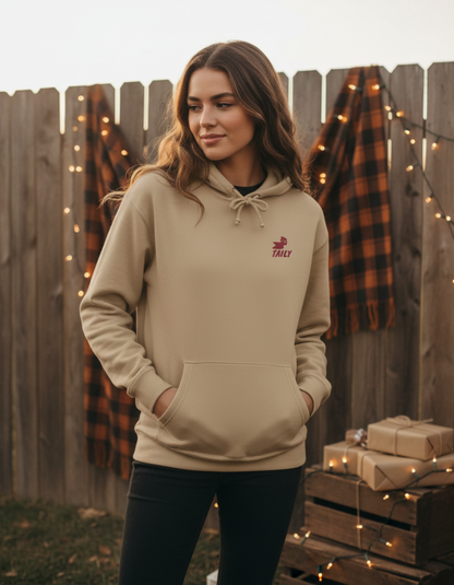 Taily Bird Parkland Hoodie in Sandstone color worn by a woman, featuring a cozy design and relaxed fit.