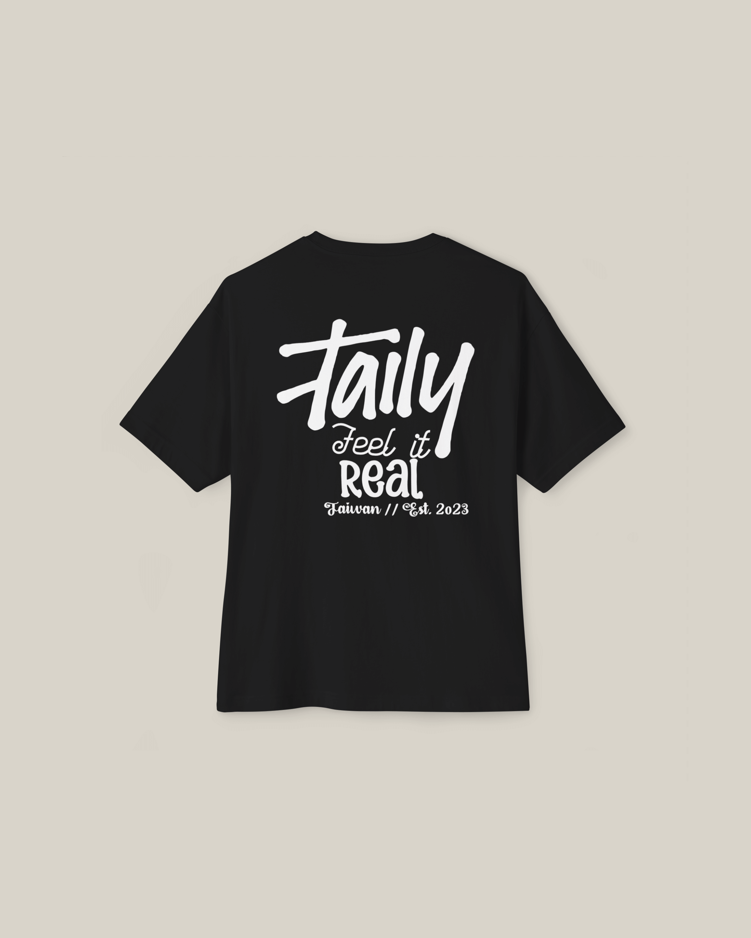 Black boxy tee featuring 'Taily Feel It Real' logo on back, stylish streetwear for comfort and attitude.