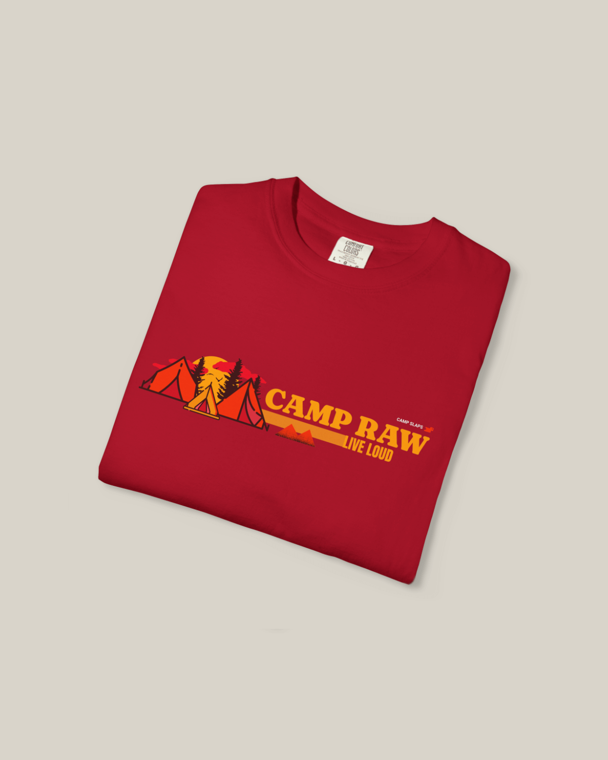 Camp RAW Tee in red, featuring tents and trees, promoting outdoor adventures and a loud, vibrant lifestyle.