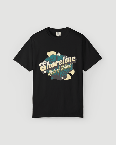Shoreline State of Mind Tee – Black featuring a vintage seashell graphic in deep teal and warm cream.