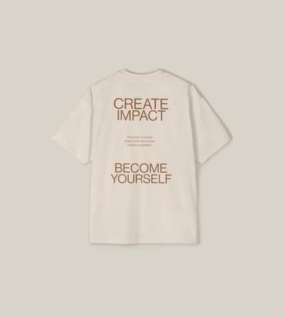 Back view of the 'Create Impact Oversized Tee' featuring motivational typography and a message of transformation.