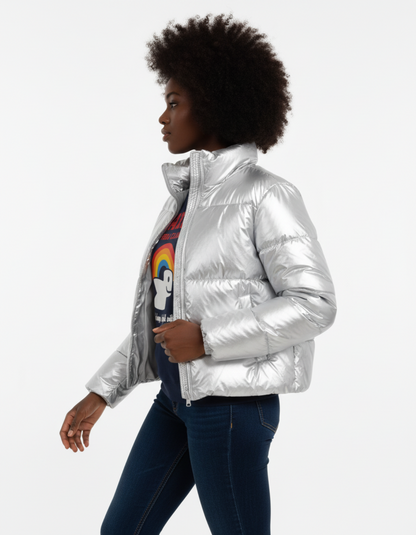 Model wearing a silver puffer jacket with a rainbow graphic tee, showcasing a stylish winter look.