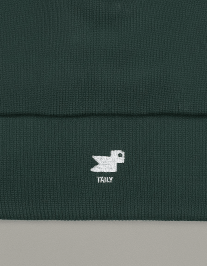 Taily Bird Knit Beanie in dark green showing minimal embroidery and comfortable fabric.