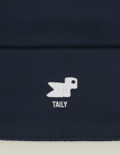 Taily Bird Knit Beanie design featuring minimal embroidery on a dark navy background.