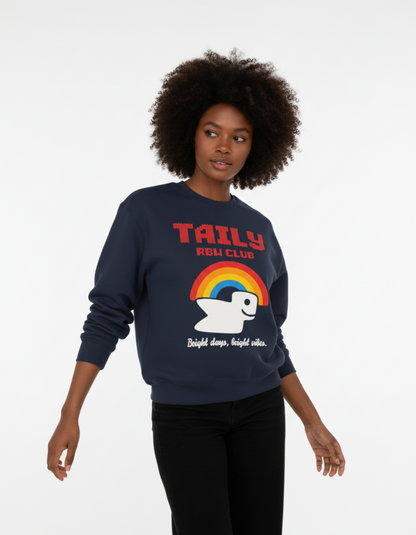 Model wearing Taily RBW Club sweatshirt in Navy with vibrant rainbow graphic