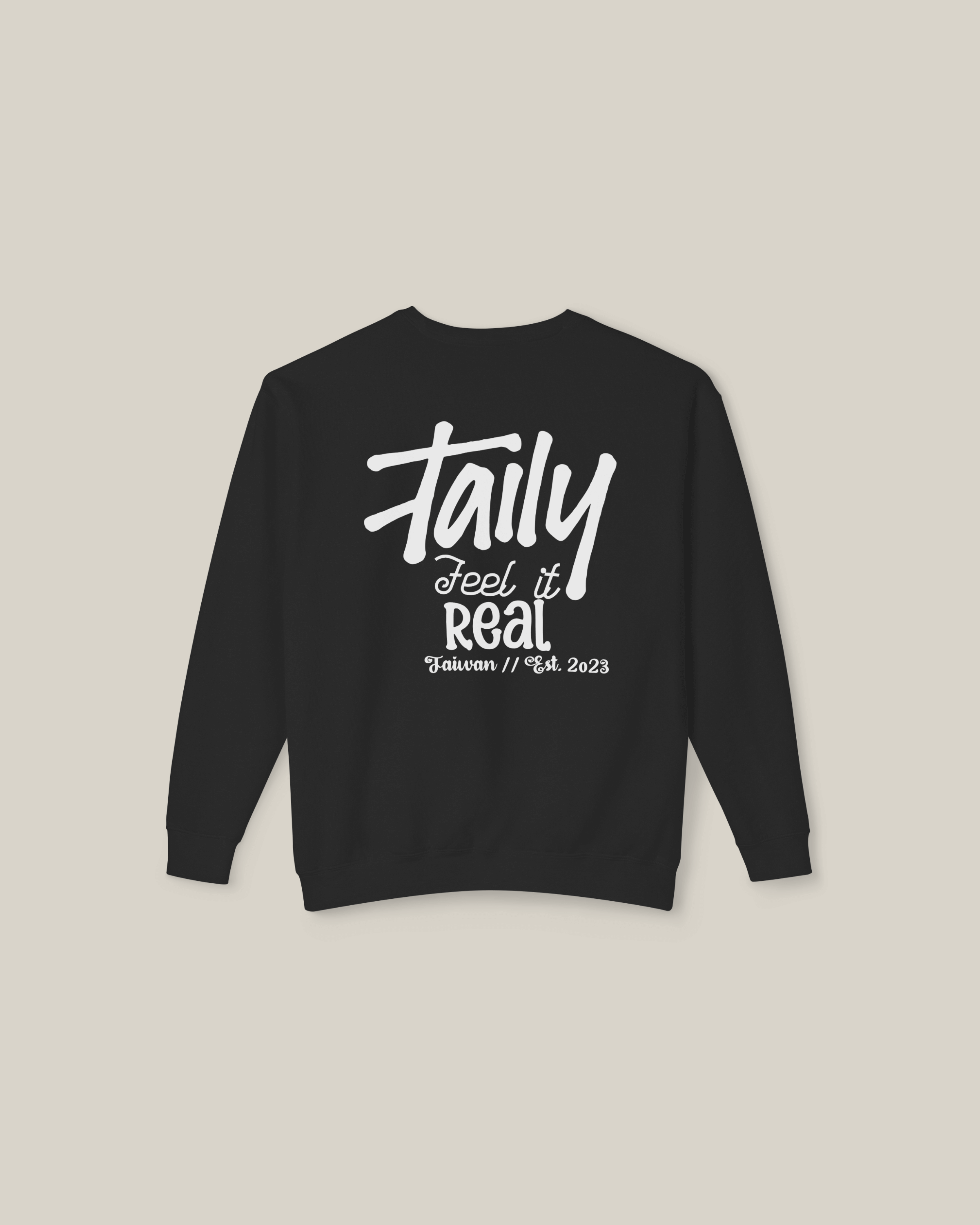 Black sweatshirt featuring bold 'Feel It Real' lettering and chest logo, perfect for streetwear style.