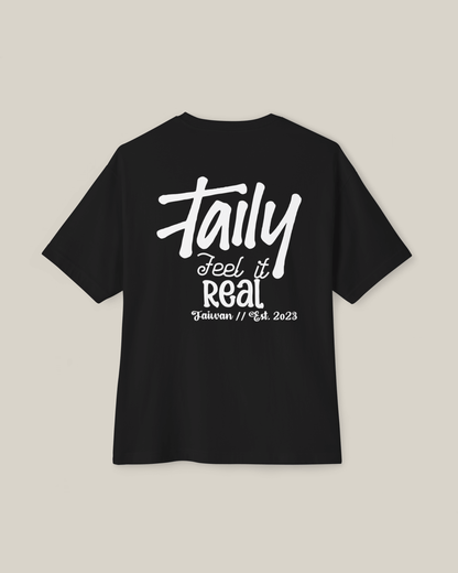 Taily Feel It Real Boxy Tee in black with bold lettering, showcasing streetwear boxy t-shirt style.