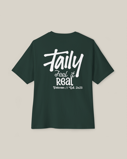Taily Feel It Real boxy tee in forest green, showcasing chest logo and bold lettering, streetwear boxy t-shirt.