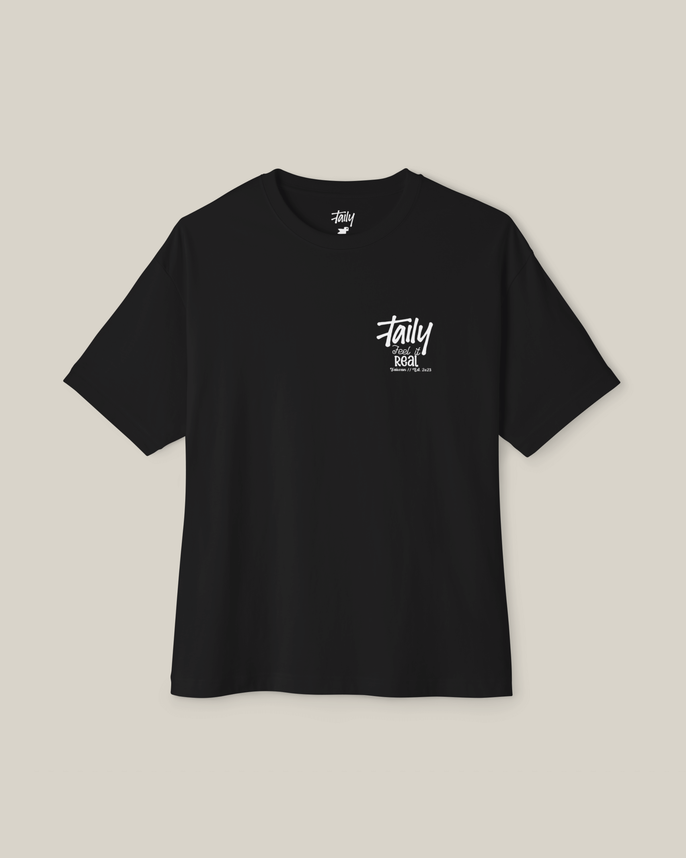 Taily Feel It Real Boxy Tee in black, a streetwear boxy t-shirt with a chest logo and bold lettering.