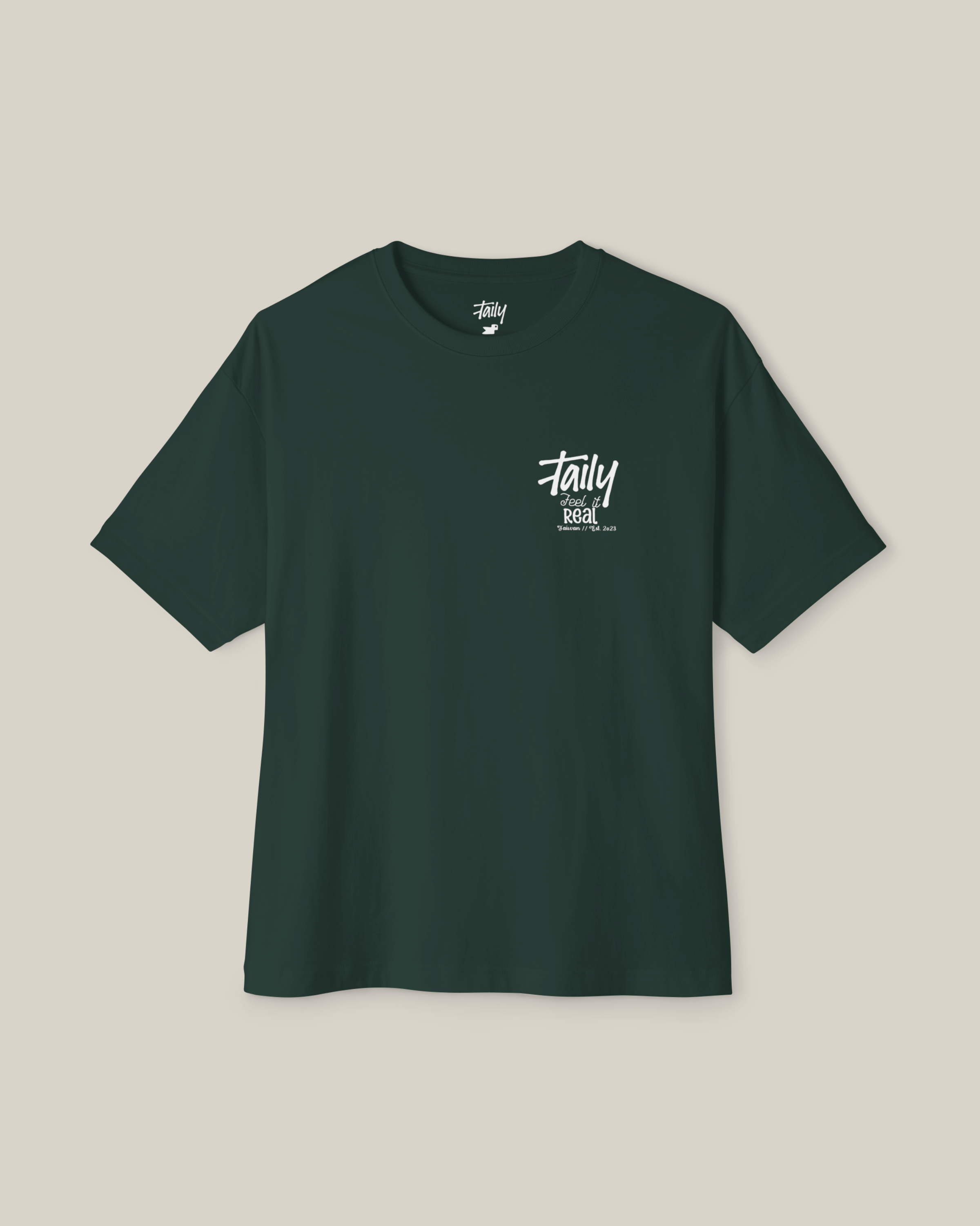 Taily Feel It Real boxy tee in forest green, a streetwear boxy t-shirt with chest logo and bold lettering.
