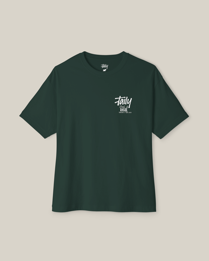 Taily Feel It Real boxy tee in forest green, a streetwear boxy t-shirt with chest logo and bold lettering.