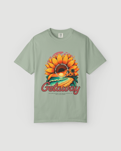 Getaway Sunflower Beach Tee – Bay with bold sunflower graphic and coastal design on a soft green shirt.