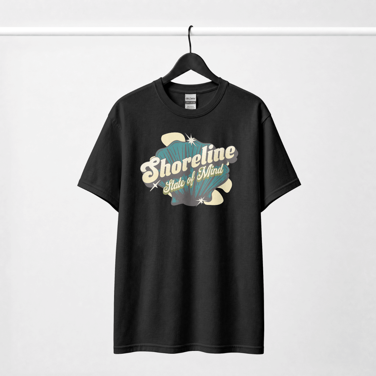 Shoreline State of Mind Tee – Black featuring a vintage seashell graphic in deep teal and cream.