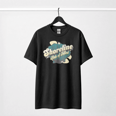 Shoreline State of Mind Tee – Black featuring a vintage seashell graphic in deep teal and cream.