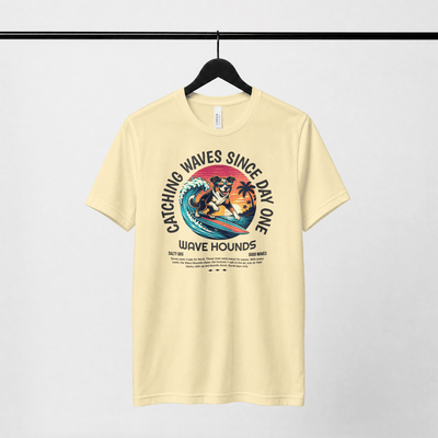 Wave Hounds Surf Tee – Banana featuring a retro surf graphic on a heavyweight tee in a light color