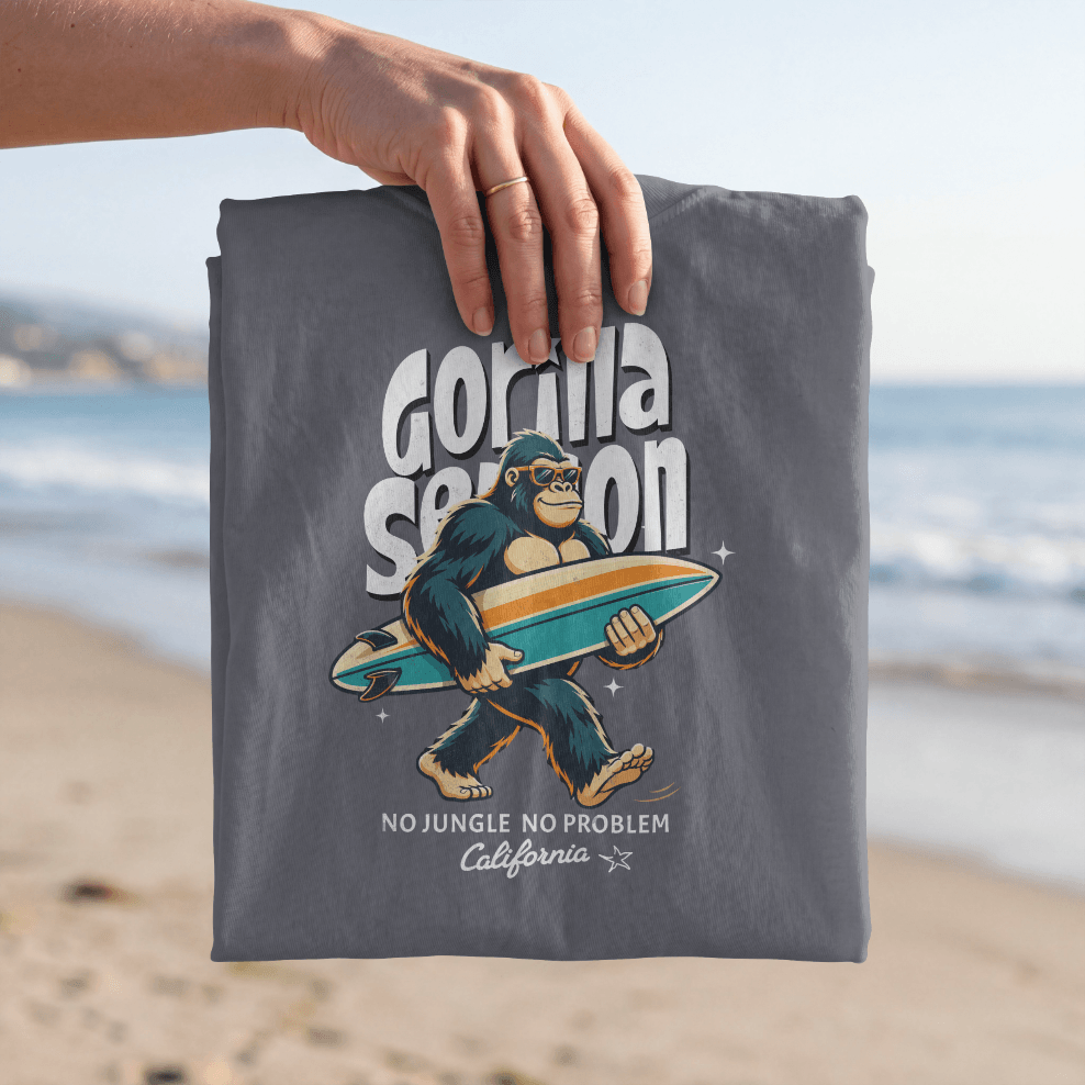 Gorilla Season Surf Tee – Navy showcasing a laid-back gorilla with a surfboard on the beach.