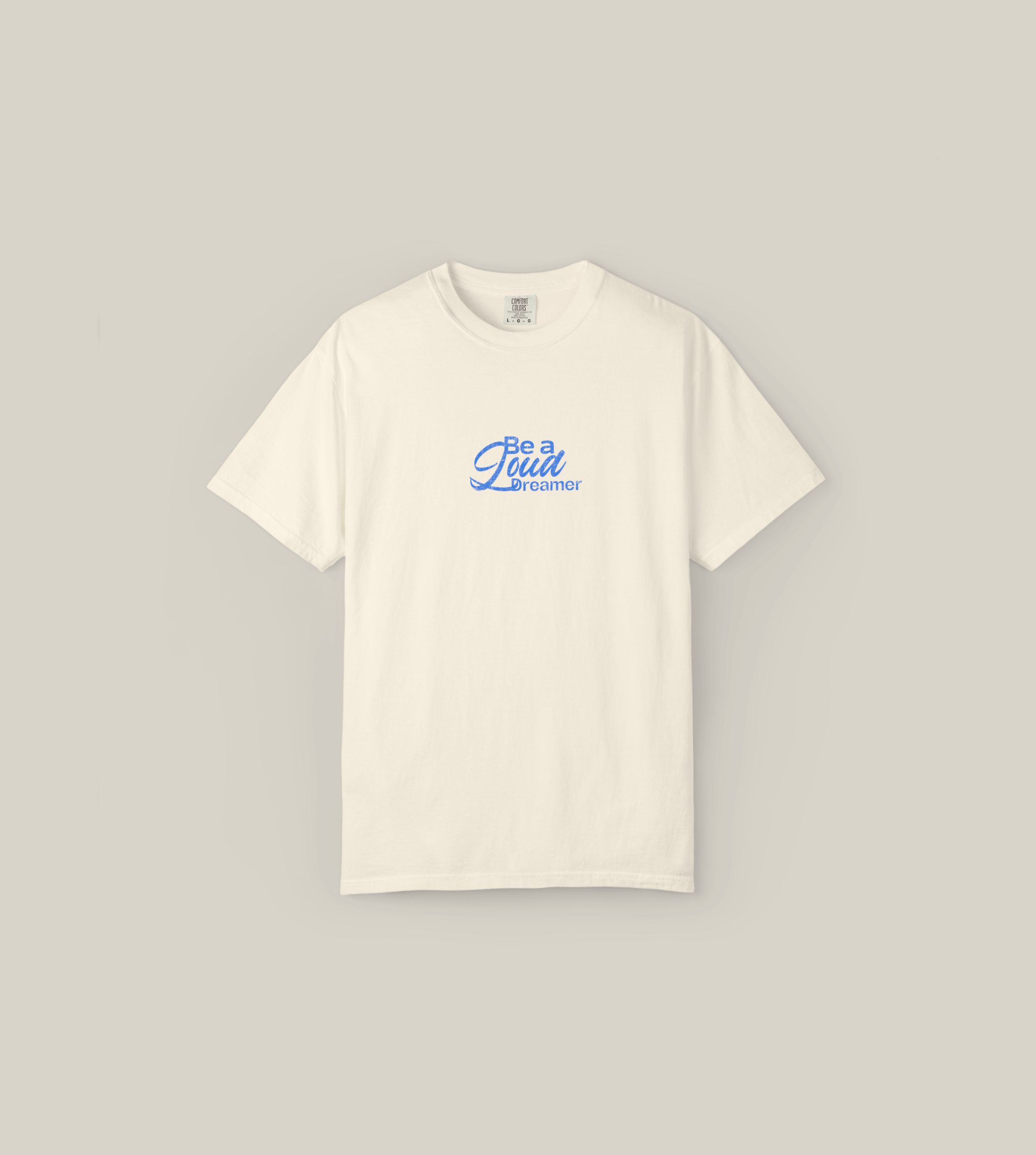 Taily Loud Dreamer graphic t-shirt in ivory featuring blue script lettering for casual streetwear style.