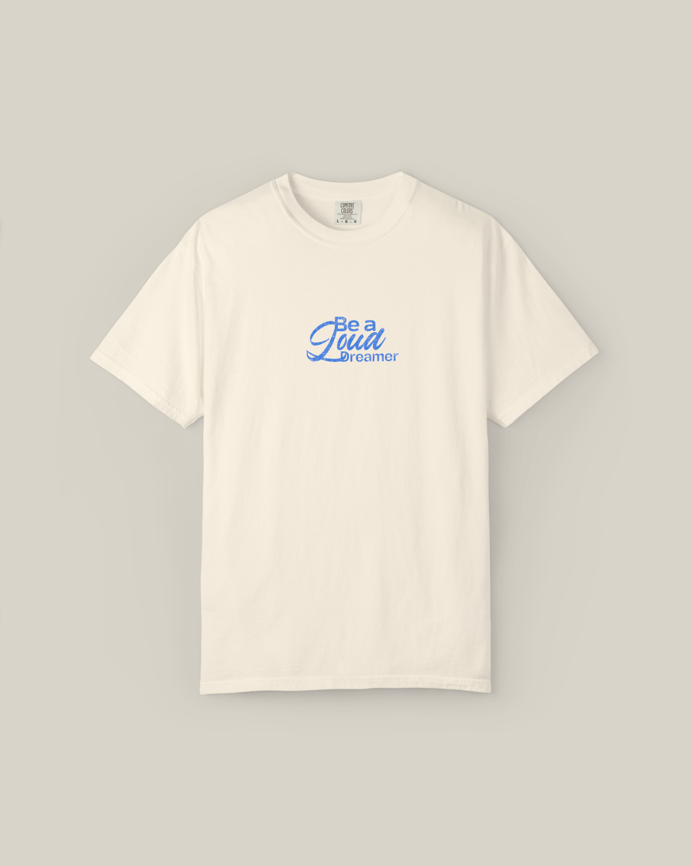 Taily Loud Dreamer Streetwear Graphic T-Shirt in ivory with bold blue lettering on the front.