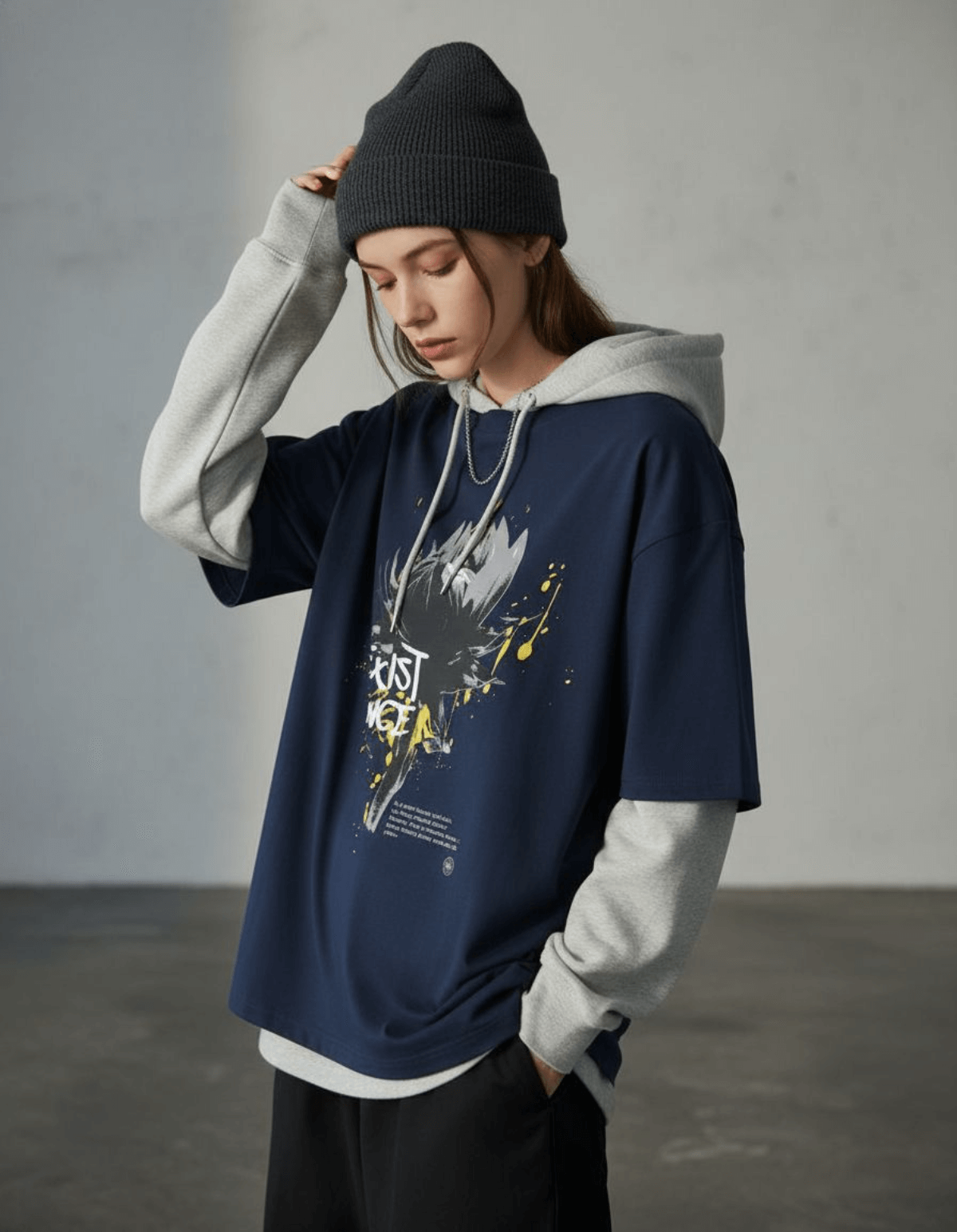 Model wearing Taily “Existence” Streetwear Oversized T-Shirt in navy with abstract artwork and a stylish hoodie.
