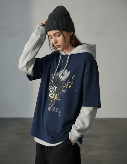 Model wearing Taily “Existence” Streetwear Oversized T-Shirt in navy with abstract artwork and a stylish hoodie.