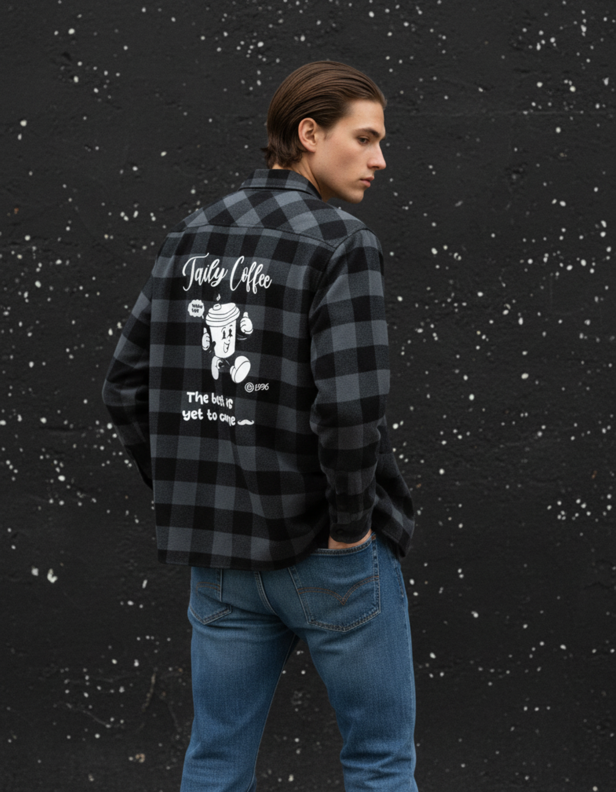 Taily Coffee flannel shirt in Charcoal Heather worn by a model against a textured wall showcasing playful café graphics.