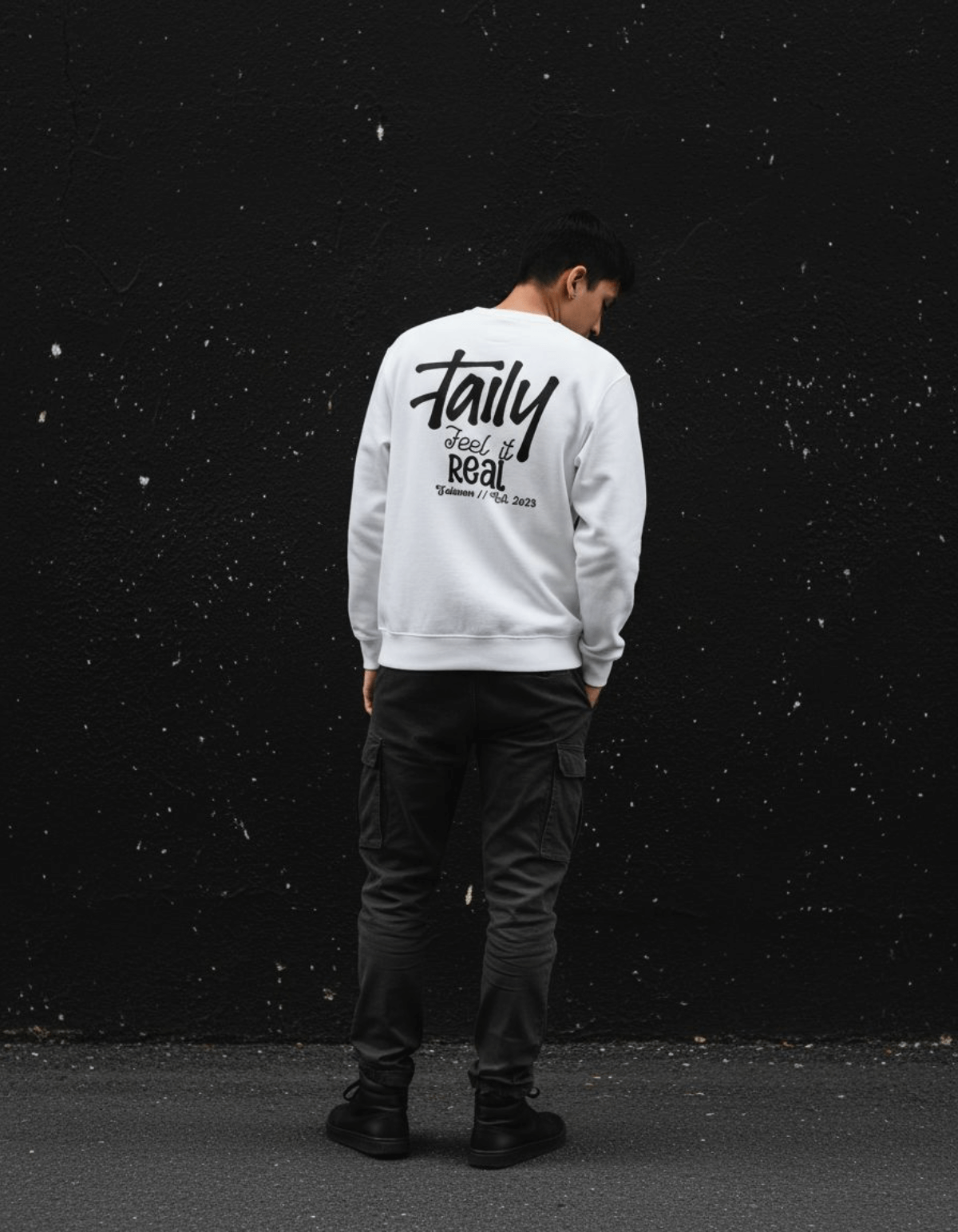 Model wearing Taily Feel It Real Sweatshirt, a streetwear graphic sweatshirt, featuring a logo on the chest and bold lettering on the back.