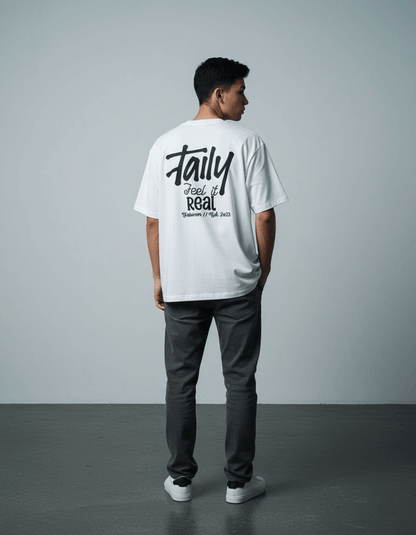 Model wearing Taily Feel It Real Boxy Tee – White, showcasing the back with the streetwear boxy t-shirt logo.