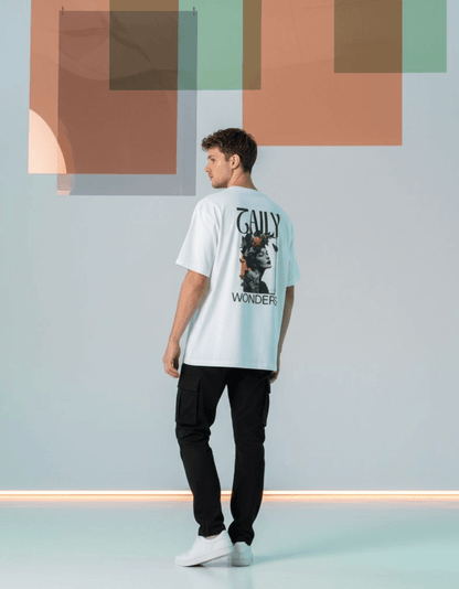 Model wearing Taily Wonders vintage boxy t-shirt in white featuring floral and butterfly designs on back.