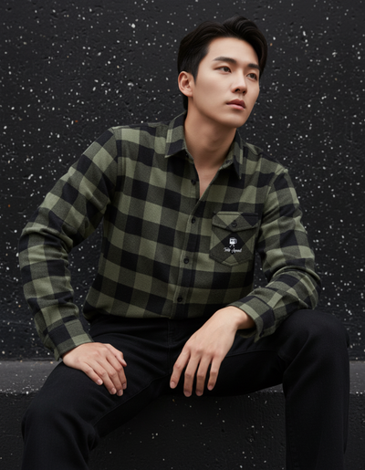 Model wearing the Taily Coffee flannel shirt in Olive with buffalo plaid pattern, featuring embroidered front pocket.