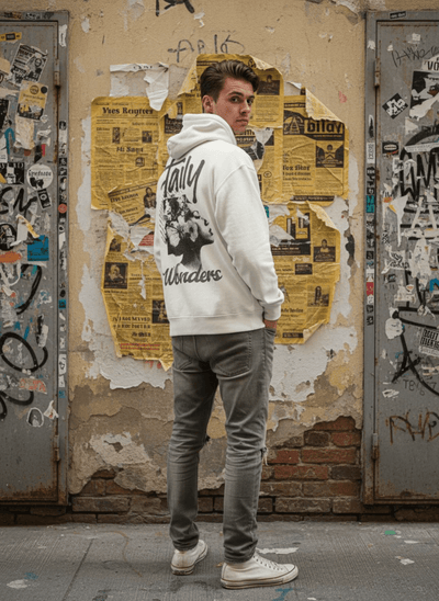 Man wearing Taily Wonders Vintage Graphic Hoodie – Oatmeal against a street art background, showcasing vintage graphic hoodie.