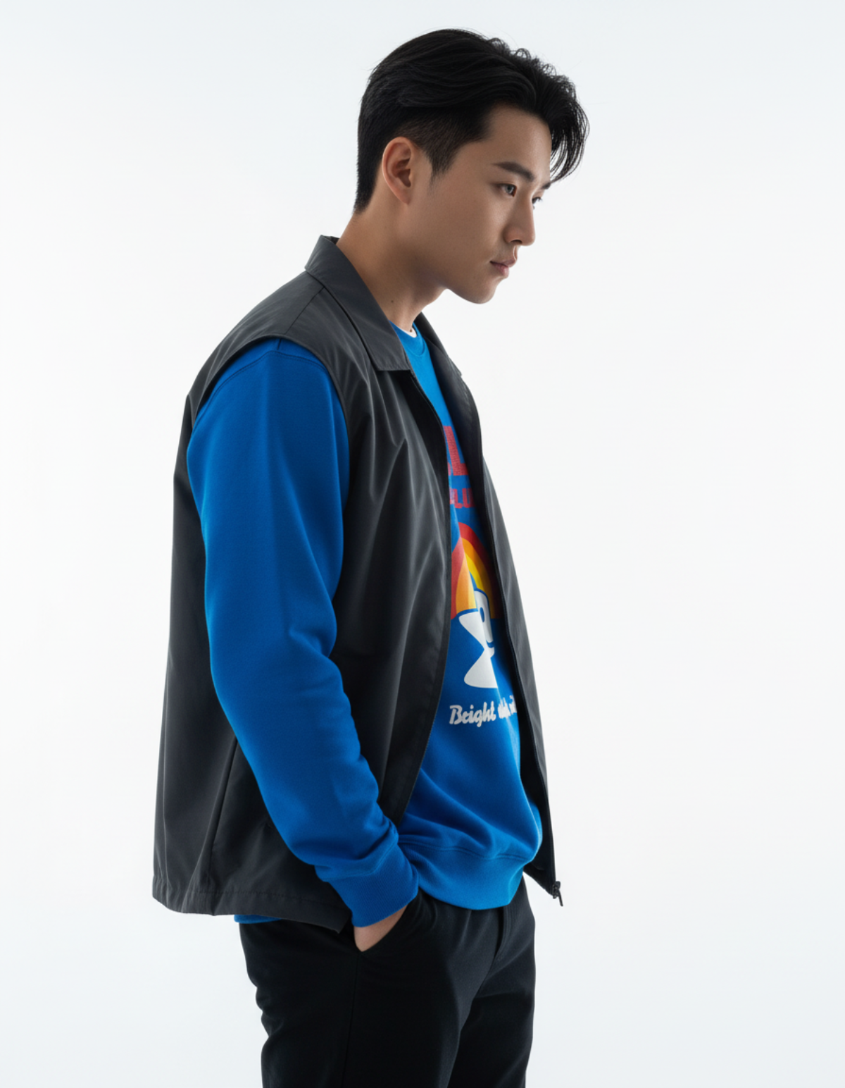 Model wearing an RBW Club sweatshirt in royal blue with a black vest, showcasing a stylish layered look.