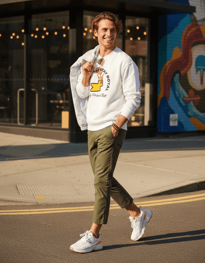 Model wearing Taily Bird Stay Cold Stay Royal Streetwear Graphic Sweatshirt in white with olive pants and sneakers.