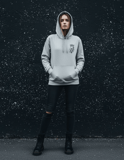 Taily Rage streetwear graphic hoodie in grey worn by a model against a textured black wall.