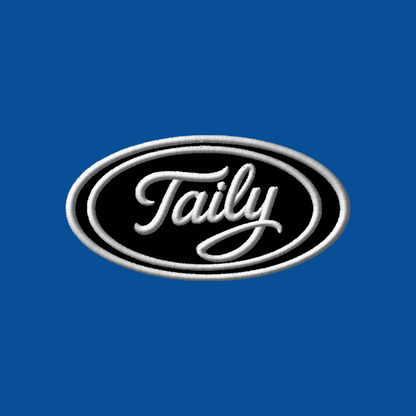 Taily logo patch in white embroidery on a black oval against a royal blue background.