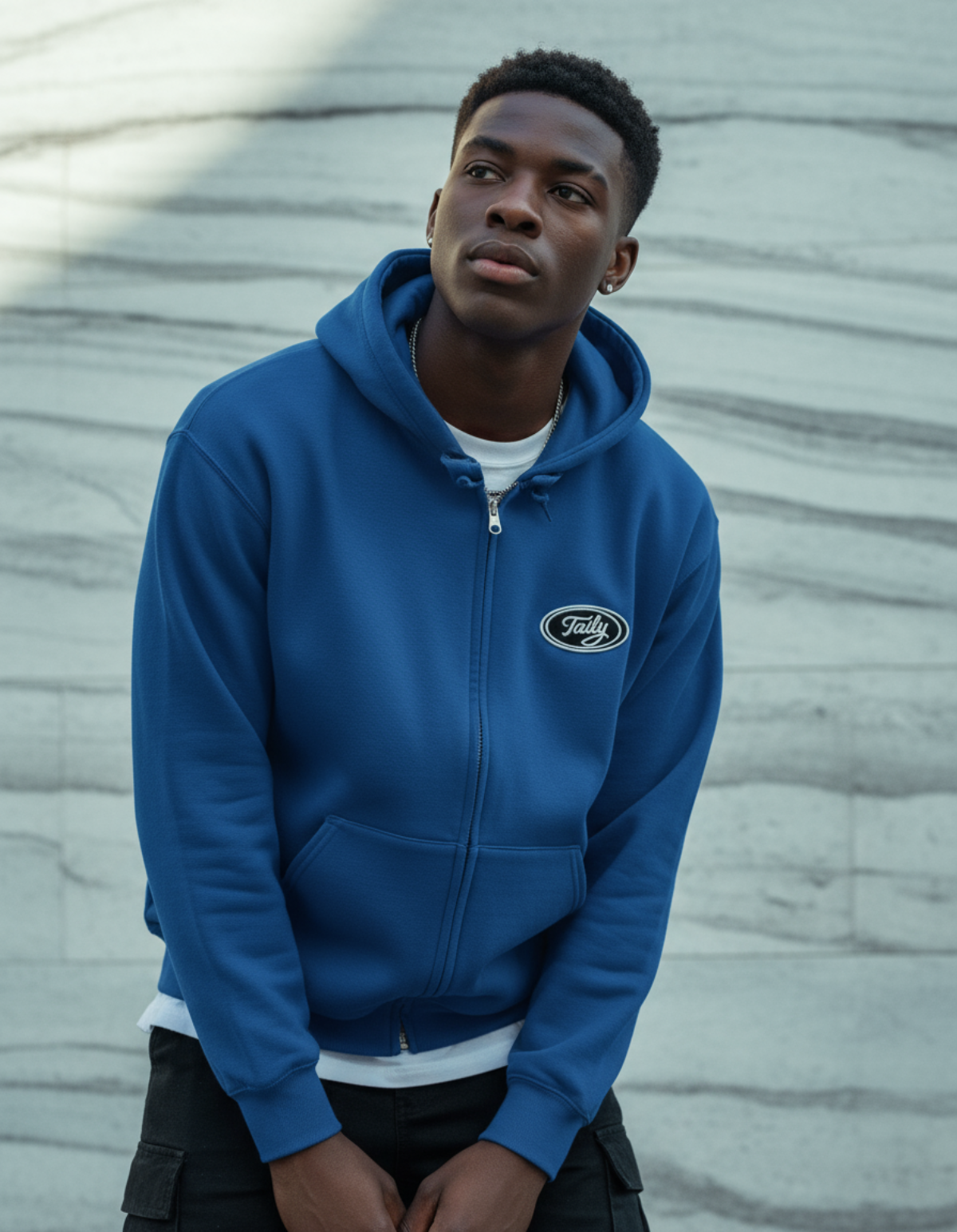 Taily Zip Hoodie in royal blue worn by model, featuring embroidered logo and relaxed fit design.
